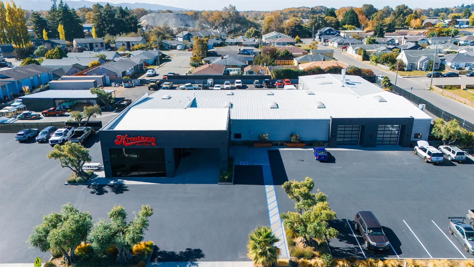 Aerial view of the Kreations Auto Body facility in Fortuna, California, with the red Kreations sign