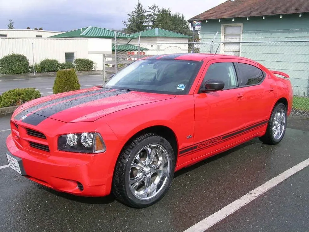 Red Dodge Charger with black racing stripes repaired at Kreations Auto Body