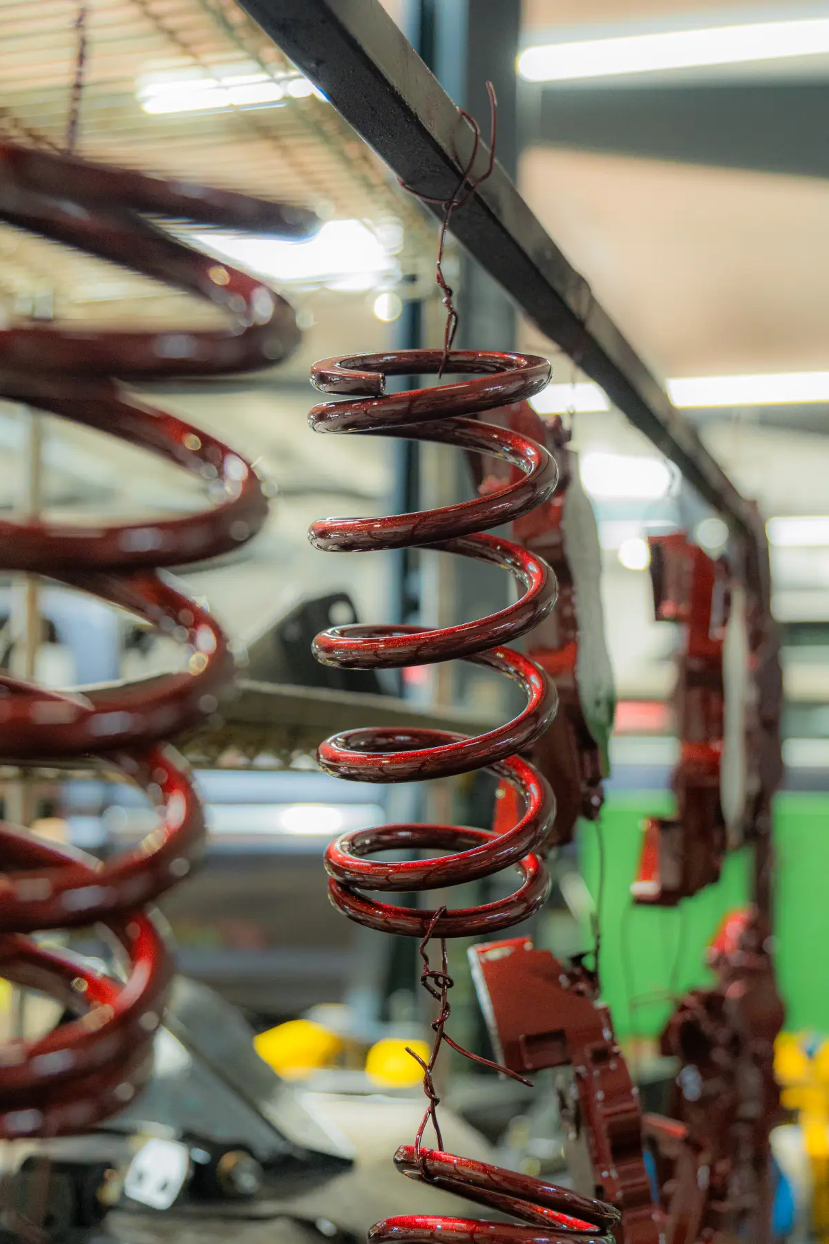 Red coilover suspension detail on a build at Kreations Auto Body