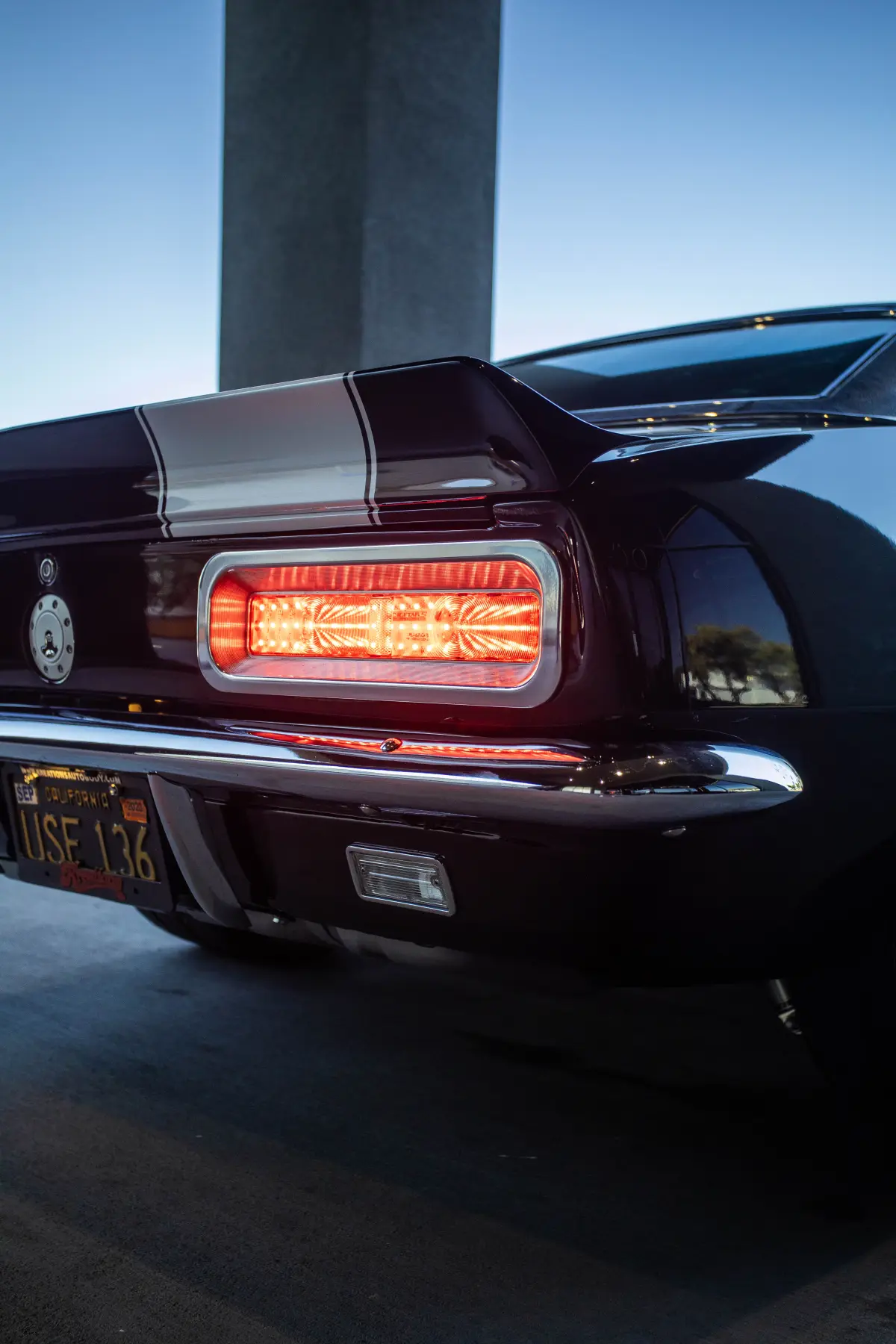 Rear and taillight detail on a maroon Ford Mustang fastback at Kreations Auto Body