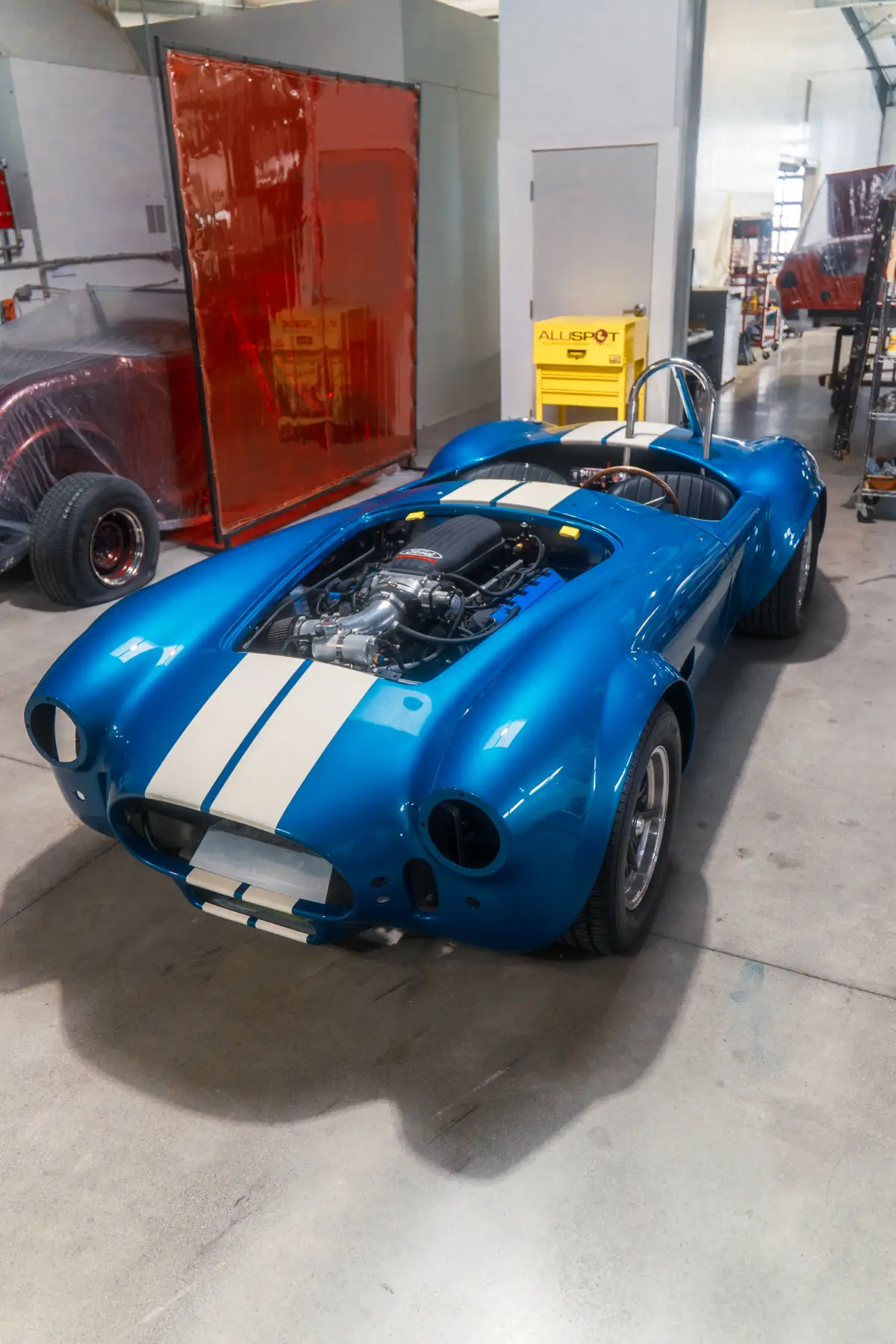 Blue Shelby Cobra with racing stripes at Kreations Auto Body