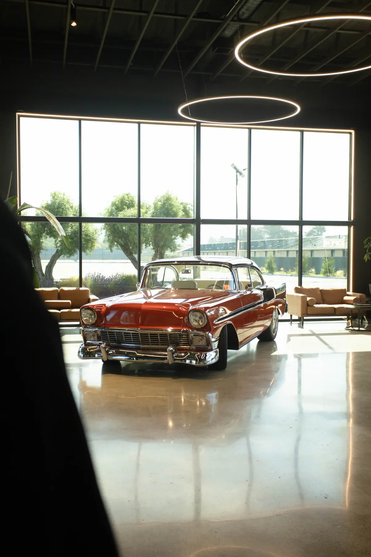 Classic car in the Kreations Auto Body showroom by the front windows