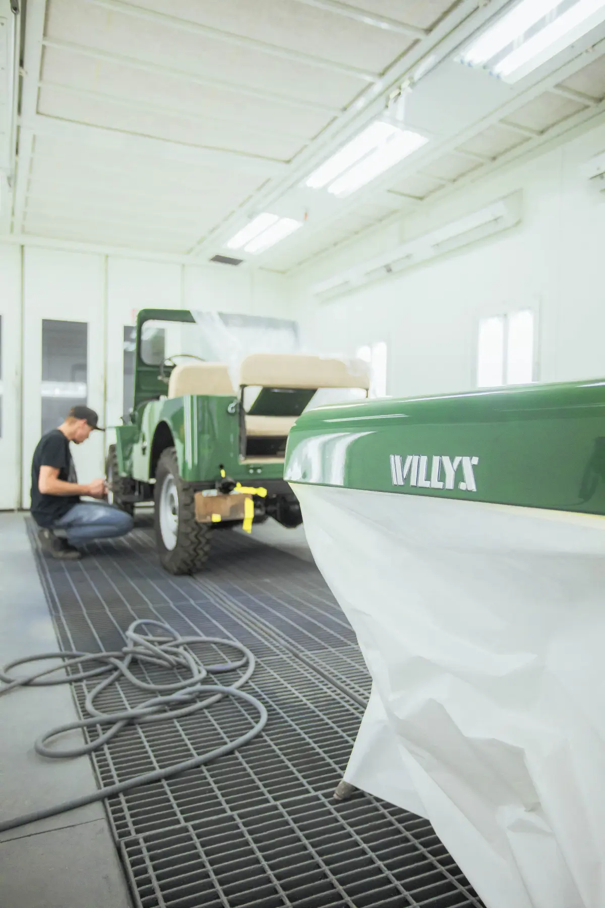 Green Willys hot rod being finished in the Kreations Auto Body paint booth