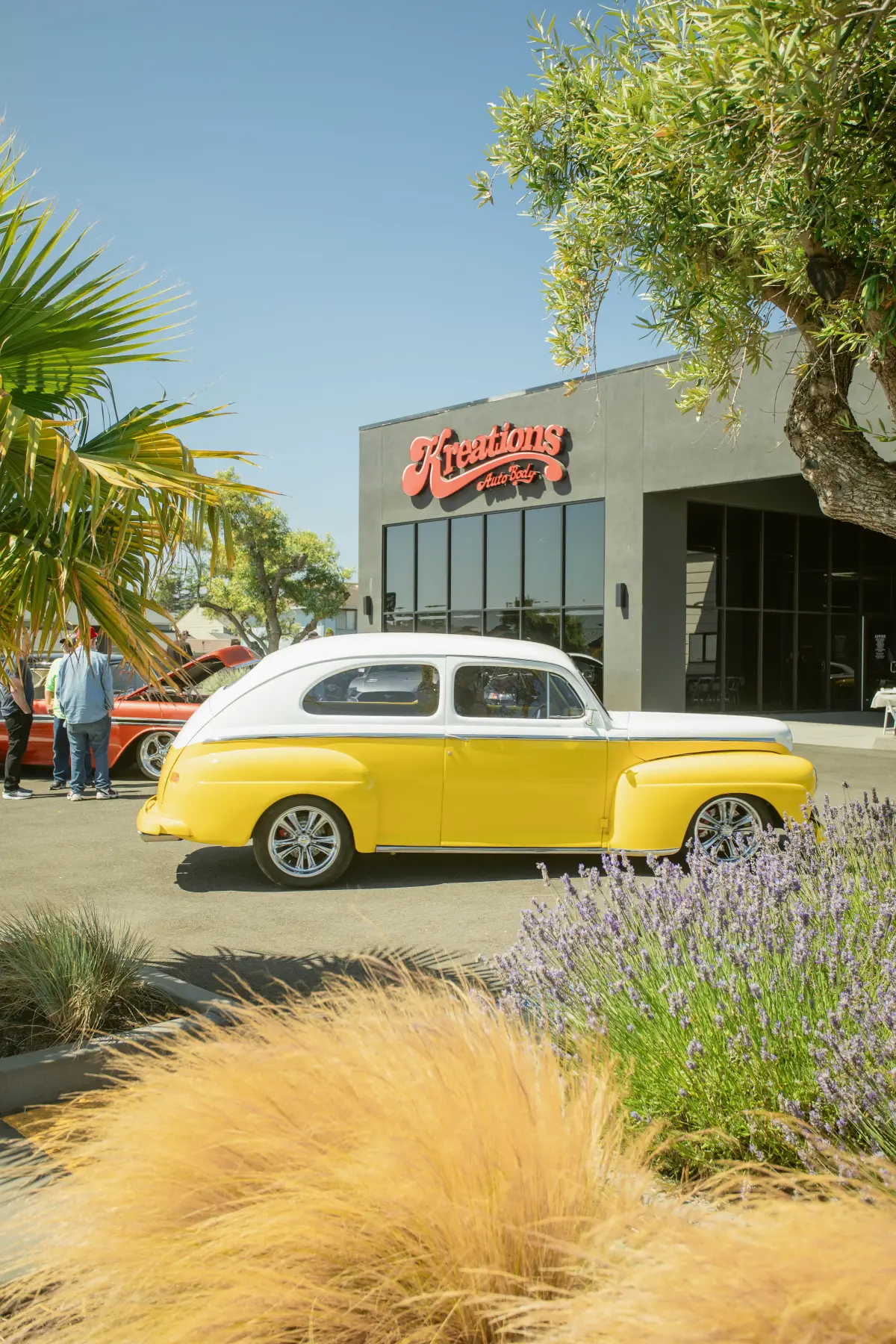 Yellow 1940s Ford coupe outside the Kreations Auto Body shop in Fortuna