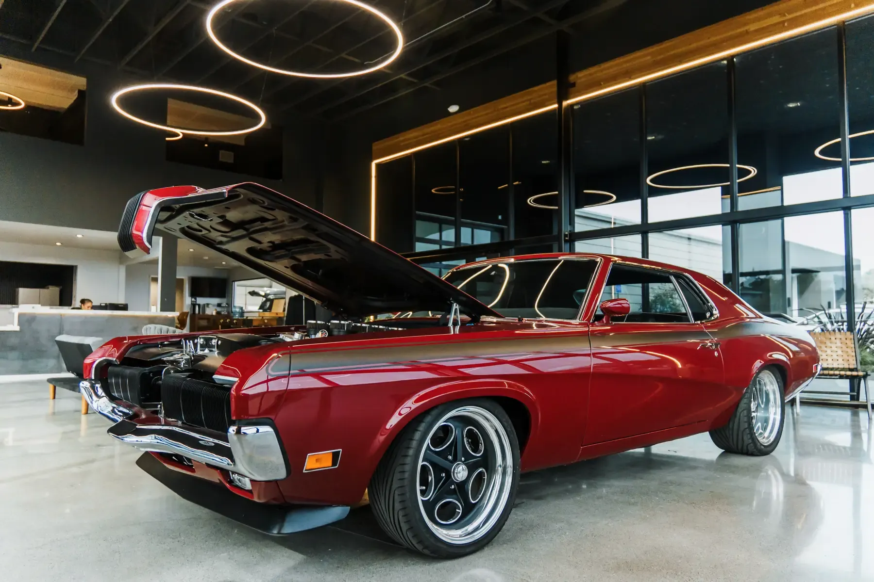 Deep-red classic muscle car under restoration in the Kreations Auto Body showroom in Fortuna